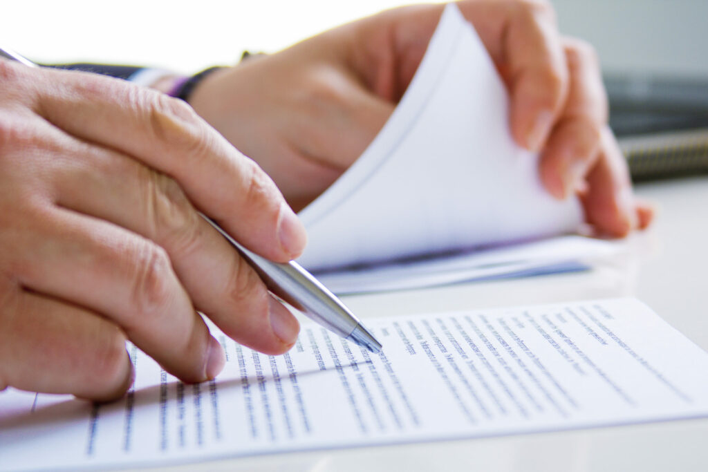 hands of business man in dark suit writing in his datebook hands of business man in dark suit writing in his datebook